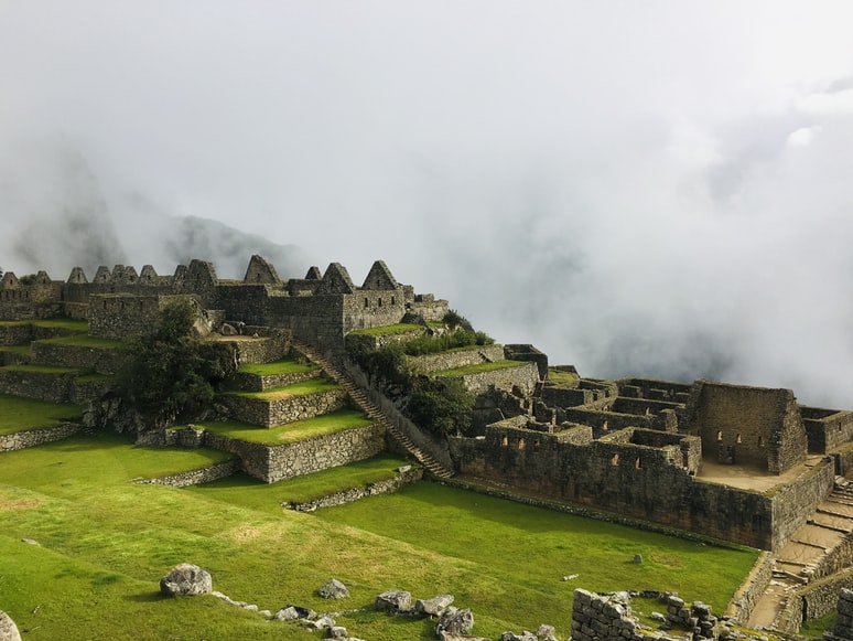 Vista  das ruínas de Machu Picchu, Peru em meio a neblina.
