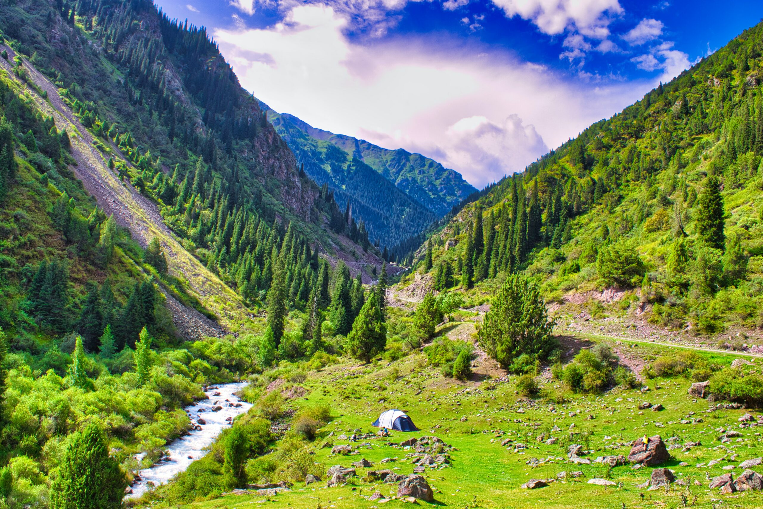 Vista do de montanhas, árvores e um rio em Kegeti, Quirguistão. Representa seguro viagem para Quirguistão.